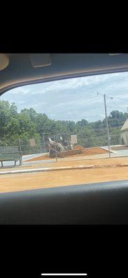 Perfectly fine pool being filled in with dirt for a pickle ball court.