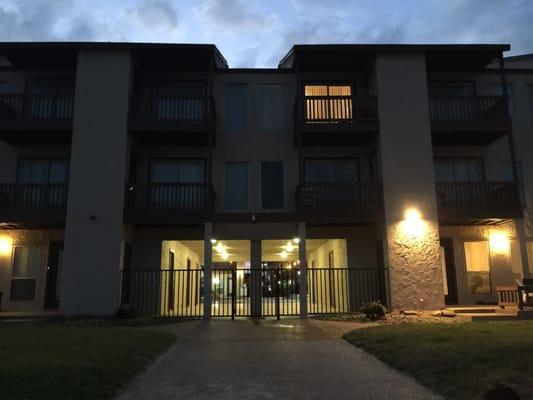 Night time view of back entrance leading into the pool hallway