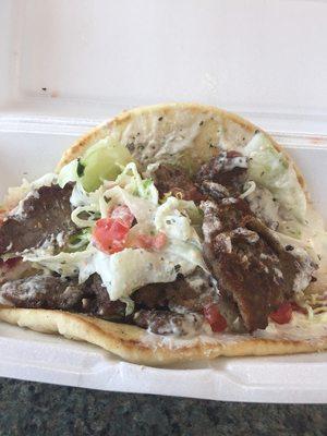 Gyro lamb meat onions, lettuce, tomato and tzatziki sauce on pita bread.