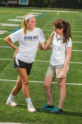 Pivot athletic trainer Katie Cicia working with a student athlete