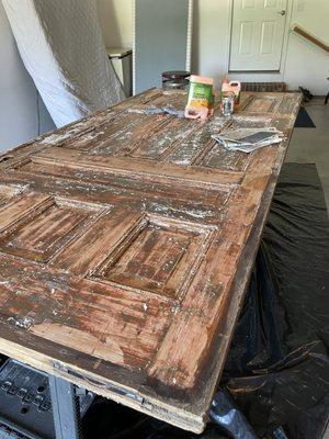 Refinishing 100 year old door out of St Louis to convert to a large dining table for guests at Hermann Grain Bins Bed & Breakfast