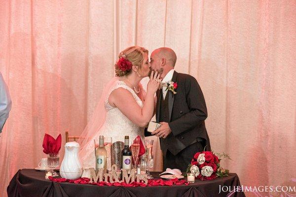 Newlyweds kissing at the head table!!