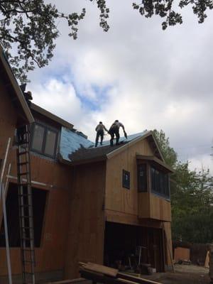 Our team installing a new 30 year composition roof On a remodeled home.