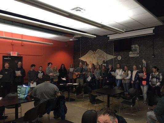 School choir singing in dining room