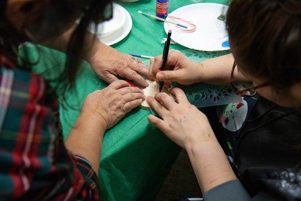 Youth and staff decorating cookies at the ARCH Holiday party