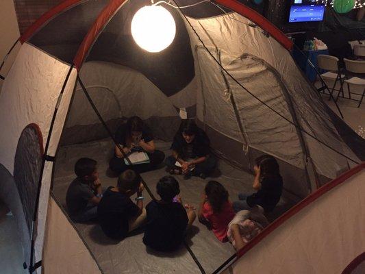 The younger kids being taught the word of God "under the stars" in a camping tent at our Summer Vacation Bible School 2017.