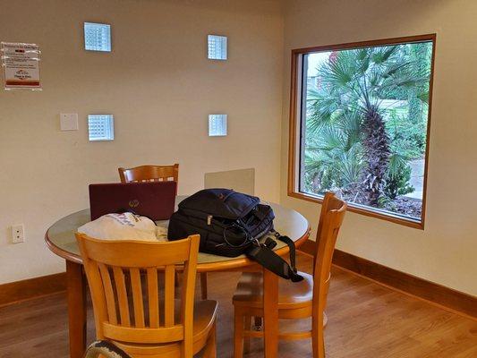 Several tables in quiet room. 1 table in this room has 2 large windows which is very nice.