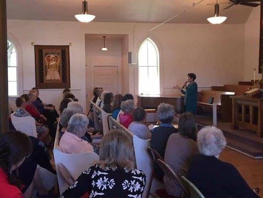 Jane Kirkpatrick, featured speaker at the 2018 Remembering Emma day in the Aurora Presbyterian Church (Pews from original Colony Church)