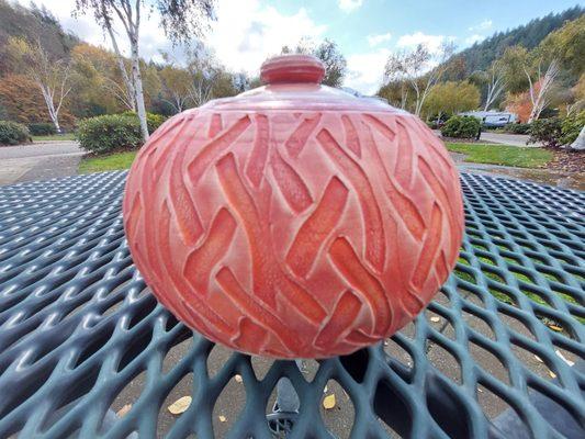 Texture rollered stoneware jar with lid.