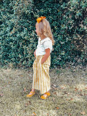 This set is sold separately. It's a Ruffle collar shirt with our pleated mustard and ivory wide leg pants. So cute.