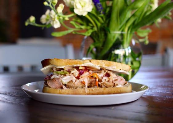 BBQ rubbed pork sandwich with havarti cheese, apple slaw and a housemade BBQ sauce