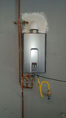 Tankless water heater installation with sheetrock repair.