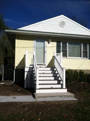 We installed new siding, windows, a new landing for the front steps and new railing.