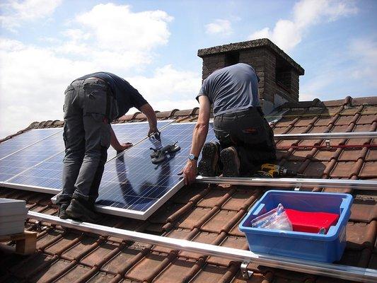 Here is a picture of solar panels being installed on a tile roof. We can install your solar panels on any roof.