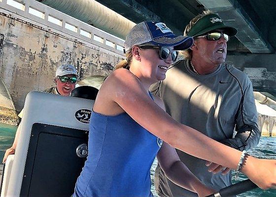 Student and Master fight Tarpon under bridge.