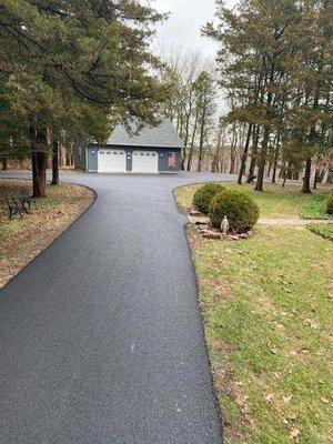 Front of home to detached garage.  Driveway goes in a circle to the left and home is to the right.