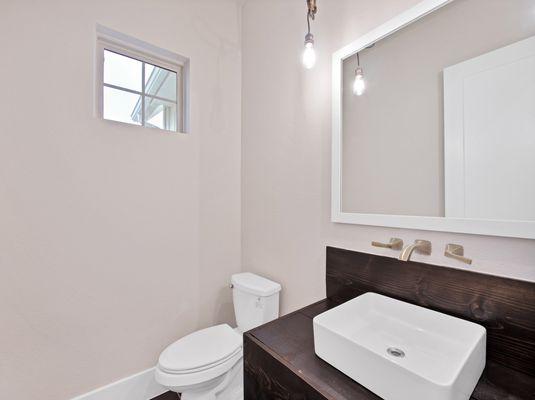 Half bath with floating vanity sink and wall mounted faucet