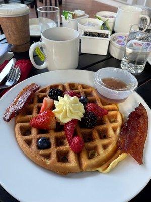 Waffle with maple bacon, fresh honey butter, maple syrup & fresh fruit.