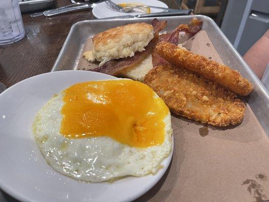 Breakfast sandwich with egg on the side.