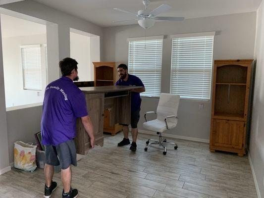 Nate and Chase arranging furniture in the new home - Hickle Family Moving