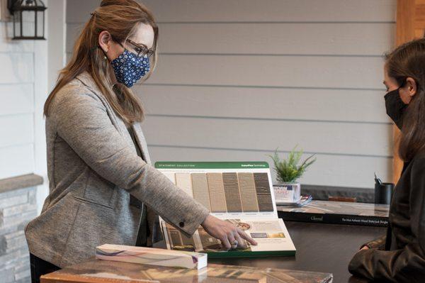 Liz showing customer James Hardie samples for a home siding project in Minnesota.