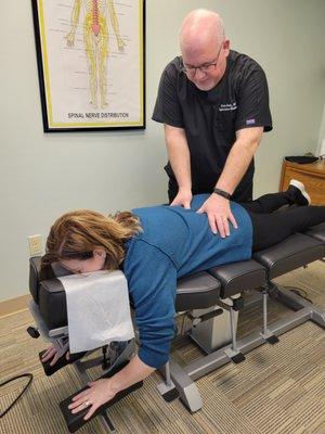 Dr. Smith checking a patient's low back.