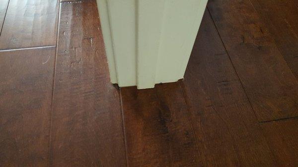 This picture shows the precise detail installing engineered hardwood under the door frame.