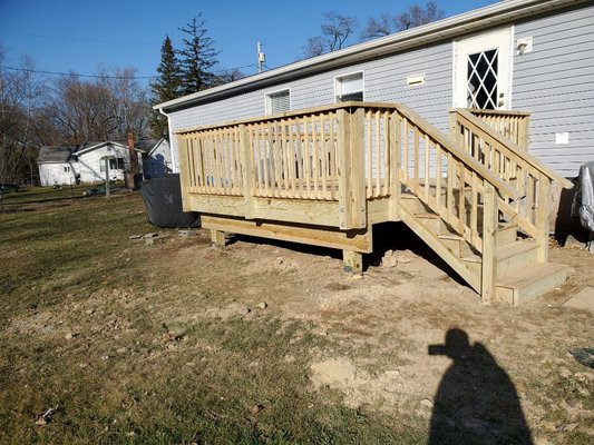 Removed existing steps and built a new pressure treated deck.