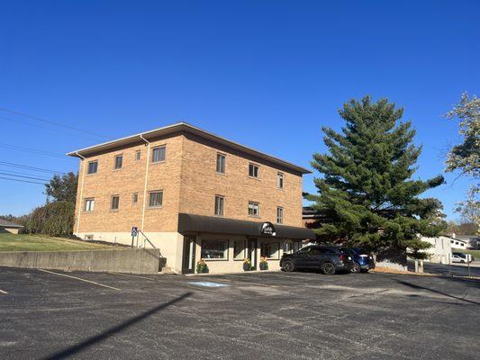 Parking lot is behind the building .