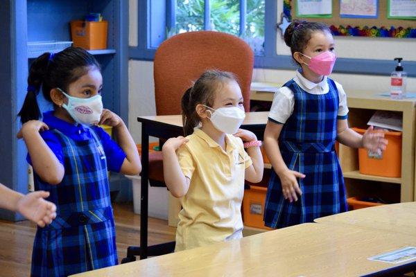 Kindergarten students do warm ups at the start of the day.