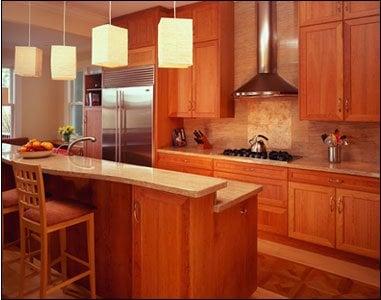 Luxurious kitchen with granite counter tops, fine cherry cabinets, stainless steel hood and oak flooring