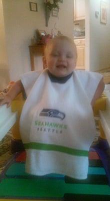 Eric in his Seahawks bib and baby mover.