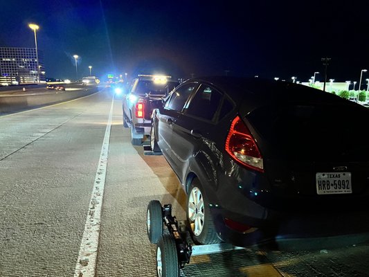 Towing Ford Fiesta with back flat tire on Dollies