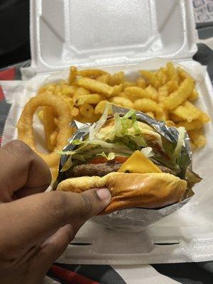 Cheeseburger n fries with one of my onion rings from my side order of onion rings