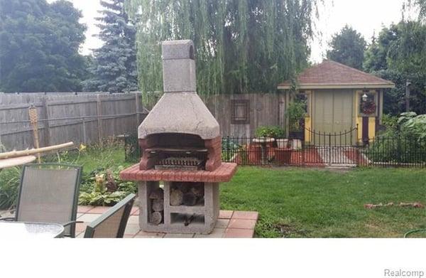 Paved back patio complete with built in stone bbq grill.  Also, lovely fenced gardens surrounding the garden shed.