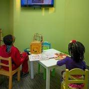 Pediatric waiting area with Netflix TV, games, books and a bean bag chair