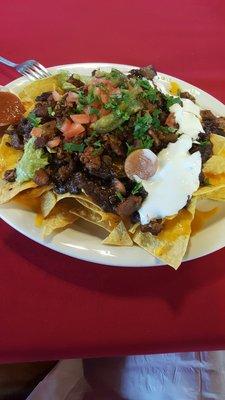 Super nachos with al pastor meat.