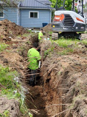 Laying the pipe and grading the slope properly