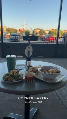 A Choose Two with Chicken Pesto and Bacon Tomato Mac & Cheese along with a Caesar Salad, in the patio area.