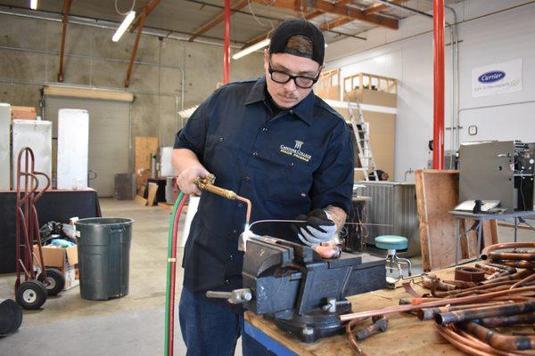 One of our students putting in work in our lab! [Photo was taken before Covid-19]