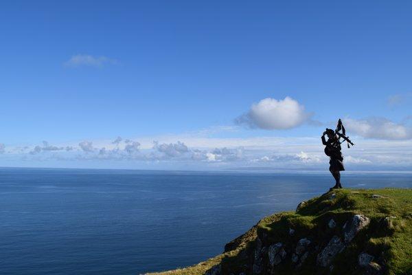 Bagpiper looking over the Sea on Isle of Skye