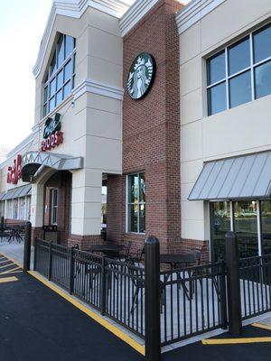 Patio seating outside on both sides of the entrance.