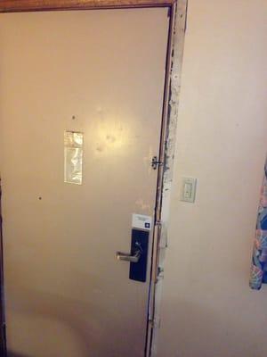 Door that was recently kicked in and not fully repaired.