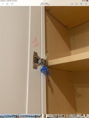 Plastic screwed into the cabinet door together with the hardware.