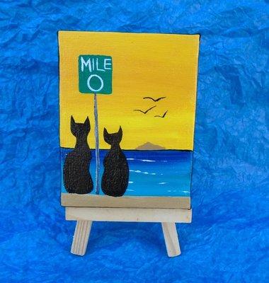 Artist Alisa Mealor Miniature Art Painting of two cats at the Mile 0 Sign watching sunset