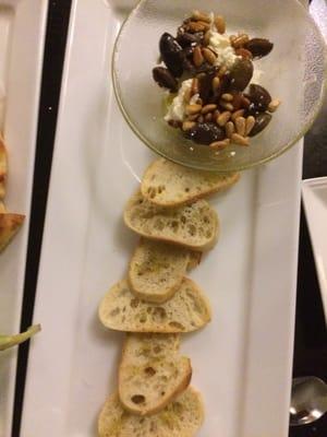 Crostini warm goat cheese with calmati olives and pine nuts