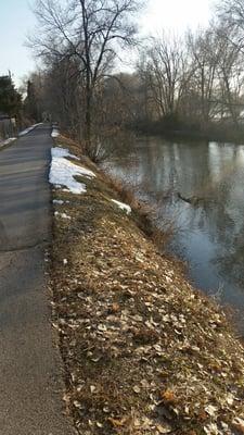 Trail across river from golf course.