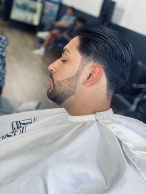 Simple slicked back cut with beard edge up by Myo the barber.