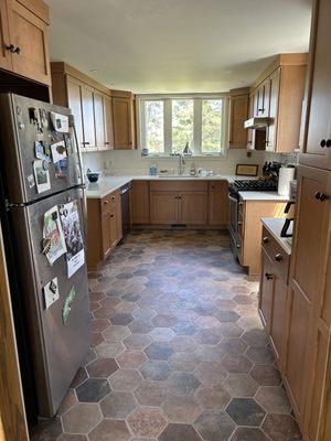 Finished kitchen with Terra Pompeii Marron Brown tile floor.