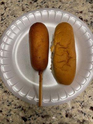 Corn dog next to a normal sized bun